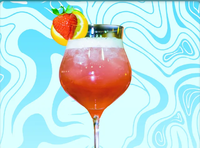 Duality of Time: a pink-to-red layered cocktail with a strawberry and pineapple wedge on the rim