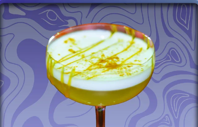 Eden's Temptation: a coupe cocktail with a foamy white top, caramel drizzle, and grated cinnamon