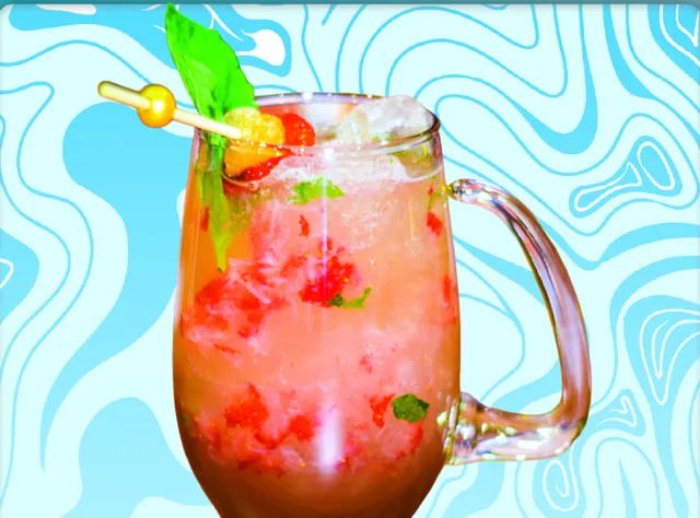 Perspection Mule: a pink mule in a glass mug with muddled strawberries and mint